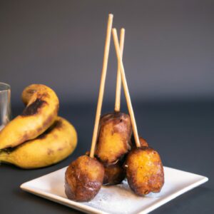 Uma panela de banana fatiada polvilhada com açúcar e canela em uma Airfryer. A banana é caramelizada e dourada, com um leve tom crocante.