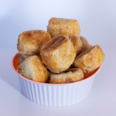 Foto de esfihas de batata crocantes e douradas cozidas na airfryer, servidas em um prato com molho de tomate para mergulhar.
