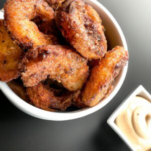 Foto de mignon suíno assado na Airfryer, coberto com uma crosta crocante e dourada. A carne é suculenta e tenra, com um toque picante de mostarda.