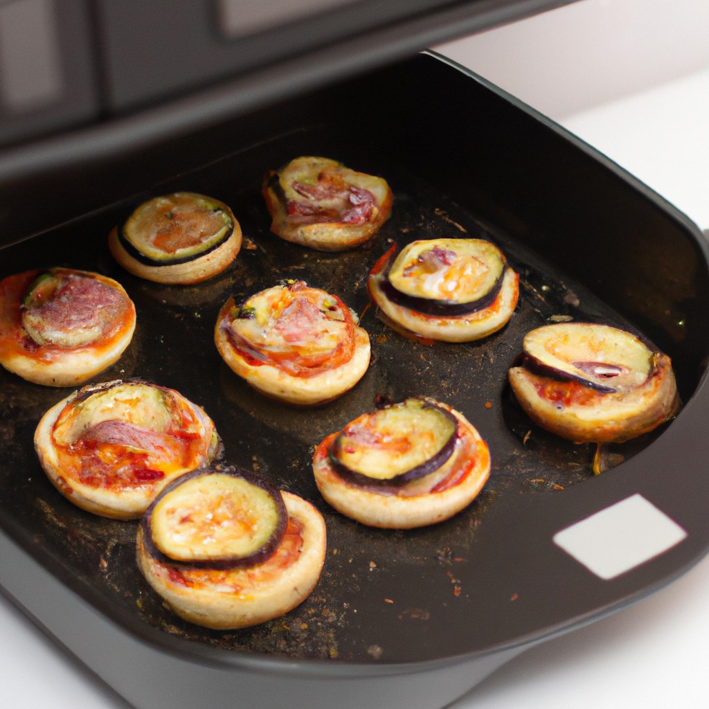 Mini Pizza De Berinjela Na Airfryer: Receita Com Passo A Passo 1 Foto de uma mini pizza de berinjela feita na Airfryer. A berinjela é cortada em fatias finas e coberta com molho de tomate, queijo e coberturas. A pizza é cozida na Airfryer até que o queijo esteja borbulhando e a berinjela esteja macia.