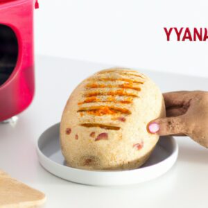 Imagem de pastel de pão de forma preparado na airfryer, com recheio de queijo e presunto, acompanhado de uma tigela de molho de tomate.