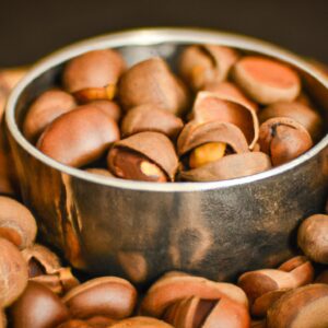 Imagem mostra uma tigela com castanhas açucaradas recém-feitas, preparadas na Airfryer. As castanhas são torradas e cobertas com uma camada crocante de açúcar caramelizado, dando-lhes uma aparência apetitosa e convidativa.