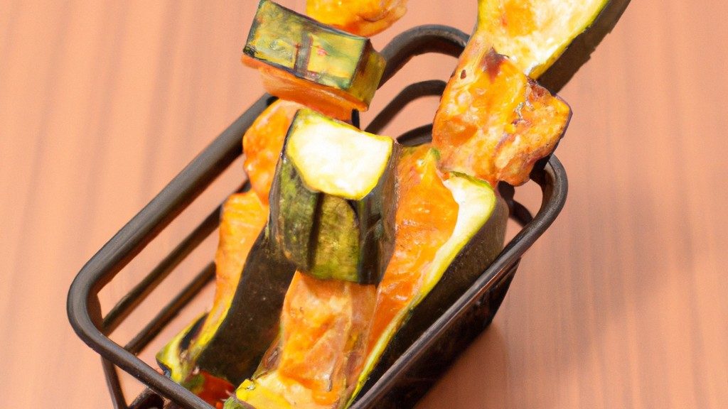 Simples E Deliciosos Palitos De Abobrinha Na Airfryer 1 Imagem de palitos de abobrinha crocantes e dourados preparados na airfryer, servidos com um molho de sua preferência. Esses palitos são uma opção de aperitivo ou lanche saudável e deliciosa, perfeitos para dias quentes de verão.