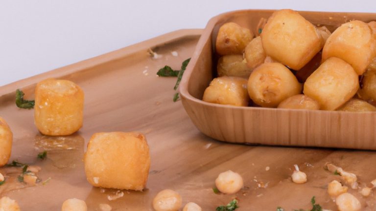 Imagem de uma Air Fryer Oster em uma bancada de cozinha. A Air Fryer é preta e tem uma cesta de cozimento removível. A imagem mostra a Air Fryer com a cesta de cozimento puxada para fora e com batatas fritas cozidas dentro. O texto 