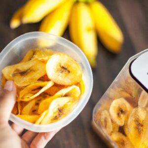 Imagem de chips de banana crocantes e dourados dispostos em uma tigela. As chips são feitas com bananas fatiadas, revestidas com canela e assadas em uma airfryer.