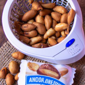 Imagem de uma airfryer com amendoins torrados dentro dela. Os amendoins são dourados e crocantes, e estão prontos para serem consumidos.