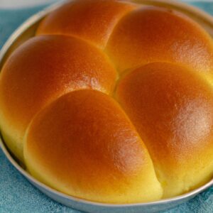 Imagem de Fátias Húngaras crocantes e douradas cozidas na Airfryer, polvilhadas com uma generosa camada de coco ralado. O pão caracol doce tem uma textura fofa e macia, com um aroma irresistível de coco e especiarias.