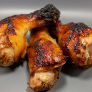 Imagem de um galeto assado na Airfryer, com pele crocante e dourada. O galeto é apresentado em um prato, guarnecido com batatas assadas e legumes grelhados.
