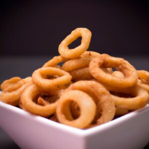 Anéis de cebola dourados e crocantes, preparados na Airfryer para uma opção mais saudável e deliciosa.