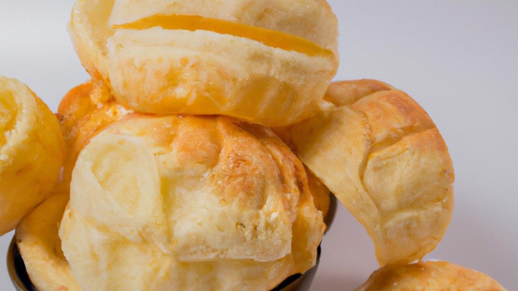 Imagem de pães de batata dourados e crocantes feitos em uma airfryer. Os pães têm uma crosta externa crocante e um interior macio e fofo. Eles são perfeitos para servir quentes com manteiga ou seu acompanhamento favorito.