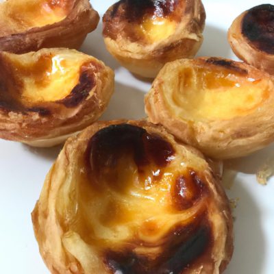 Pastel de Nata assado na Airfryer, com sua massa folhada crocante e creme de ovos cremoso, polvilhado com canela em pó.