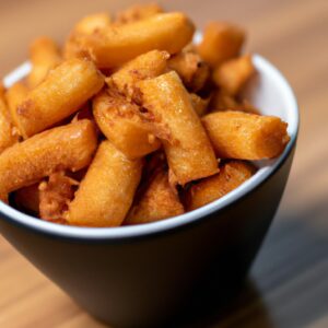Imagem de palitos de muçarela crocantes e dourados preparados na Airfryer. Os palitos são feitos com queijo mussarela de alta qualidade, empanados com farinha de rosca temperada e fritos até ficarem crocantes e derretidos por dentro. A imagem mostra os palitos dispostos em uma cesta de fritadeira, prontos para servir como um aperitivo delicioso e satisfatório.